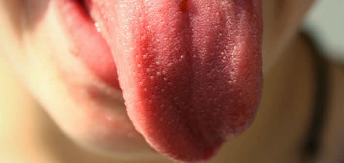 A tongue sticks out in disgust, covering most of the mouth and chin beneath it.