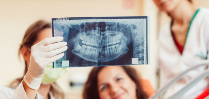 How much do veneers vs implants cost? Our Little Rock dentists explain how to weigh the differences between porcelain veneers and dental implants.