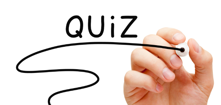 A hand holding a marker has written "QUIZ" and underlined it with a flourish.